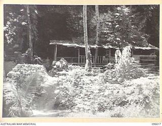 BONIS PENINSULA, BOUGAINVILLE. 1945-09-15. LIVING QUARTERS OF THE NAVAL COMMANDER, AT THE JAPANESE NAVAL HEADQUARTERS, BONIS PENINSULA. THE HOUSE FRONT IS BUILT OFF THE CLIFF FACE AND ACCOMMODATION ..