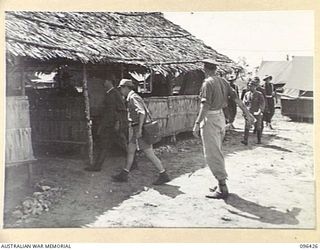 CAPE WOM, NEW GUINEA, 1945-09-13. COLONEL SUGIYAMA, SENIOR JAPANESE OFFICER LIEUTENANT-GENERAL ADACHI'S CHIEF OF STAFF, AND JAPANESE STAFF OFFICERS OF 18 JAPANESE ARMY, ARRIVING AT THE BATTLE ROOM, ..