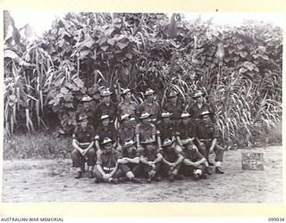 Group portrait of the personnel of 45 Supply Depot Platoon, 30 Advanced Supply Depot. Left to right, back row: NX149344 Corporal (Cpl) B A Fuller of Bexley, NSW; QX58534 Private (Pte) W G Hine of ..