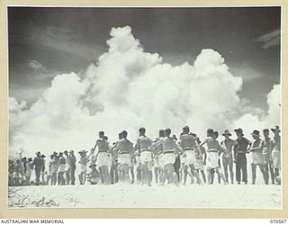 KELANOA, NEW GUINEA, 1944-02-20. THE 4TH INFANTRY BATTALION, (NO. 2 TEAM), IN THE MARCHPAST AT THE MOST FORWARD BEACH CARNIVAL HELD IN NEW GUINEA. THE CARNIVAL WAS ORGANISED BY CAPTAIN A.E. ..