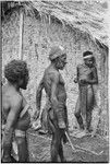 Returned laborers, purification ritual: preparations are made for sacrificial feast, next to new-style house built by the returnees