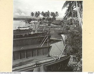 LABU, NEW GUINEA, 1944-03-10. A MIXTURE OF VESSELS UNDER REPAIR AT THE 1ST WATERCRAFT WORKSHOP, AUSTRALIAN ELECTRICAL AND MECHANICAL ENGINEERS. THE WORKSHOPS ARE KEPT BUSY REPAIRING LANDING CRAFT, ..