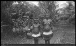 Women and girls of the Trobriand Islands, some balancing baskets on heads