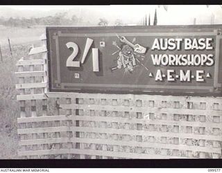 LAE, NEW GUINEA, 1945-11-20. THE SIGN AT THE ENTRANCE TO 2/1 BASE WORKSHOPS, CORPS OF AUSTRALIAN ELECTRICAL AND MECHANICAL ENGINEERS