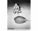 Mr. V. E. Brock with a 100 lb. sting ray he speared in the water off Prayer Island, summer 1947