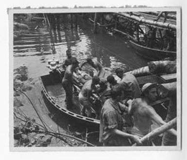 [Injured Soldier Being Removed From Small Boat]