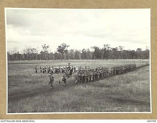 WONDECLA, QLD. 1944-04-15. MEMBERS OF "C" COMPANY, 2/1ST INFANTRY BATTALION GIVE "EYES RIGHT" AS THEY MARCH PAST THEIR COMMANDING OFFICER, NX163 LIEUTENANT COLONEL P.A. CULLEN, DSO. (4), WITH THE ..