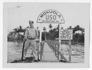 [Serviceman Beside Mokuola USO Sign]