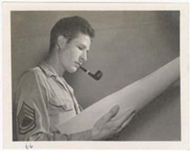 [Serviceman looking at document]