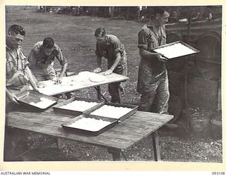 WEWAK AREA, NEW GUINEA, 1945-06-13. COOKS FROM VARIOUS 6 DIVISION UNITS, ATTENDING A COURSE AT HQ 6 DIVISION, CONDUCTED BY LHQ COOKING AND CATERING SCHOOLS, SEEN ROLLING AND PLACING BREAD ROLLS ON ..