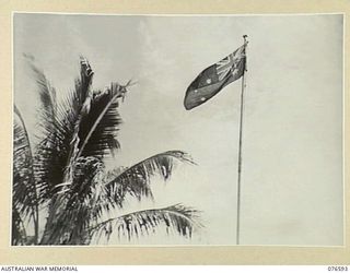 HOSKINS, NEW BRITAIN. 1944-10-13. THE AUSTRALIAN FLAG FLYING OVER THE CAP AREA OF THE 36TH INFANTRY BATTALION