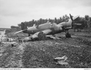 MILNE BAY, PAPUA. C. 1942-10. A DAMAGED BEAUFIGHTER AIRCRAFT OF NO. 30 SQUADRON RAAF WHICH HAD COLLIDED WITH A HUDSON BOMBER AIRCRAFT OF NO. 6 SQUADRON RAAF WHILE LANDING ON THE MUDDY GURNEY ..