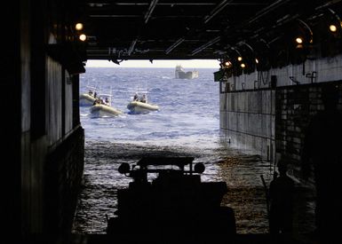 U.S. Navy Landing Craft Utility 1658 (back) and several Rigid Hull Inflatable Boats prepare to enter the well deck of the Tarawa Class Amphibious Assault Ship USS SAIPAN (LHA 2) during operations in the Mediterranean Sea on Aug. 31, 2006. SAIPAN is currently underway conducting maritime security operations. (U.S. Navy photo Mass Communication SPECIALIST Second Class Steven J. Weber) (Released)