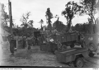 TOROKINA, BOUGAINVILLE ISLAND. 1945-01-30. SUPPLIES FOR AUSTRALIAN UNITS IN THE AREA BEING LOADED ON TO TRUCKS AT THE 4TH SUPPLY DEPOT PLATOON