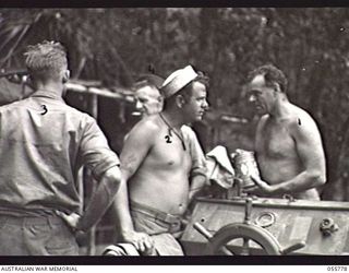 MOROBE, NEW GUINEA. 1943-08-13. MEMBERS OF THE UNITED STATES SMALL SHIPS SECTION. LEFT TO RIGHT:- SERGEANT WILLIAM MURRAY (UNITED STATES); MR M. J. GILMORE, SALVAGE MASTER (SYDNEY); PRIVATE CHIEKE ..