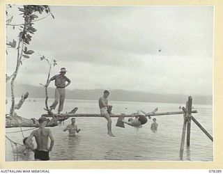 SWAN BEACH, NEW BRITAIN. 1945-01-07. AN ABRUPT END TO ONE OF THE HEATS IN THE PILLOW FIGHT ON THE GREASY POLE AT THE SWIMMING AND BOATING CARNIVAL ORGANISED BY HEADQUARTERS, 13TH INFANTRY BRIGADE. ..