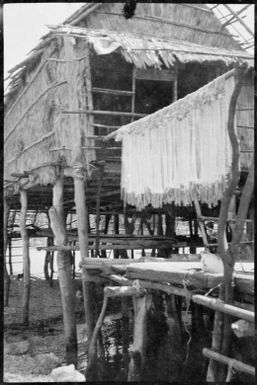 Nets drying in front of a house, Hanuabada, Papua, ca. 1923 / Sarah Chinnery