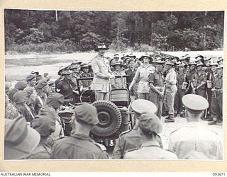 HONGORAI RIVER, BOUGAINVILLE, 1945-07-04. HIS ROYAL HIGHNESS, THE DUKE OF GLOUCESTER, GOVERNOR-GENERAL OF AUSTRALIA (1), ADDRESSING TROOPS FROM HIS JEEP DURING HIS INSPECTION OF 3 DIVISION AREA