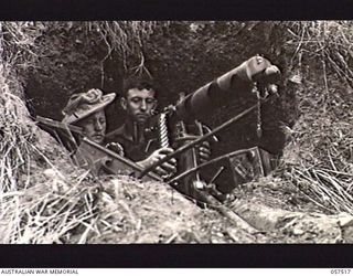 KAIAPIT, NEW GUINEA. 1943-09-23. SX13290 PRIVATE (PTE) M. D. AUSTIN (LEFT) AND SX13334 PTE W. G. SHATTOCK, BOTH OF THE 2/27TH AUSTRALIAN INFANTRY BATTALION, POSITIONING A VICKERS GUN OVERLOOKING ..