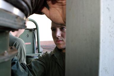 US Marine Corps (USMC) Sergeant (SGT) Chad Kiehl, assigned to Marine Corps Forces Pacific (MARFORPAC) G-3, Combat Camera, removes an air-conditioning pipe from a Combat Camera and Printing (CC&P) portable van, in preparation for its deployment to Iraq, at Camp H.M. Smith, Hawaii (HI), in support of Operation IRAQI FREEDOM