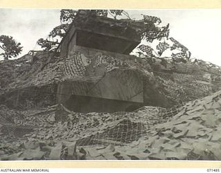 PORT MORESBY, PAPUA. 1944-03-27. THE CAMOUFLAGED COMMAND POST AT PAGA BATTERY, COAST ARTILLERY VIEWED FROM THE FRONT OF THE GUN FLOOR. THE BATTERY, EQUIPPED WITH A SEARCHLIGHT AND TWO SIX INCH ..