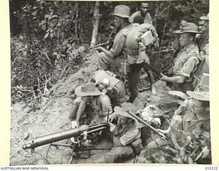 1943-07-08. NEW GUINEA. WAU-MUBO AREA. AN AUSTRALIAN PATROL MOVES OUT ALONG THE MUBO TRACK IN A FORWARD AREA. (NEGATIVE BY G. SHORT)