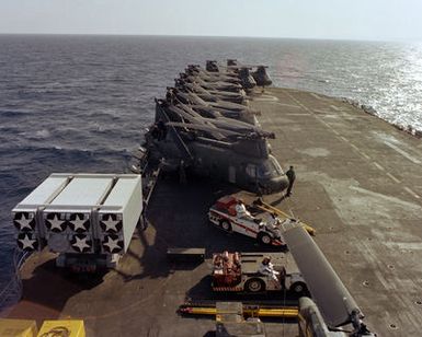CH-46 Sea Knight helicopters, damage control vehicles and cargo line the flight deck of the amphibious assault ship USS GUAM (LPH-9), during flight operations off the coast of Beirut. The ship is providing support to U.S. Marines deployed in Lebanon as part of a multi-national peacekeeping force following confrontation between Israeli forces and the Palestine Liberation Organization