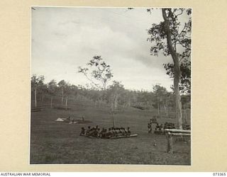 BISIATABU, NEW GUINEA. 1944-05-23. A GENERAL VIEW OF THE PARADE GROUND WITH NATIVE TROOPS OF THE PAPUAN INFANTRY BATTALION UNDERGOING DRILL INSTRUCTION