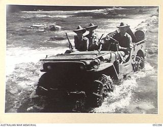 BOUGAINVILLE, 1945-05-18. TROOPS OF 15 FIELD COMPANY ROYAL AUSTRALIAN ENGINEERS AND 57/60 INFANTRY BATTALION CROSS THE HONGORAI RIVER AT DURHAMS CROSSING IN A JEEP CARRYING STORES. IDENTIFIED ..