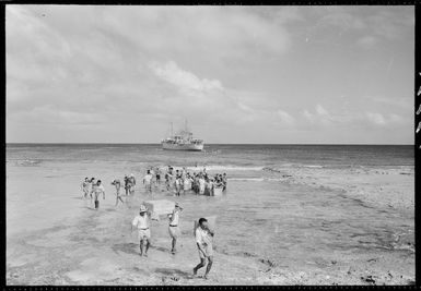 Men unloading cargo, Mauke Island, Cook Islands - Photograph taken by Mr Malloy