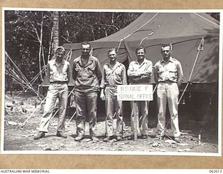 DREGER HARBOUR, NEW GUINEA. 1943-12-05. SIGNAL OFFICER AND OFFICERS OF HEADQUARTERS, UNITED STATES BASE "F" AND THE 22ND PORT HEADQUARTERS, UNITED STATES ARMY SERVICES OF SUPPLY OUTSIDE THE TENT ..