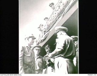 THE SOLOMON ISLANDS, 1945-08-19. AN ENVOY OF LIEUTENANT GENERAL MASATANE KANDA, COMMANDER JAPANESE XVII ARMY, WITH AUSTRALIAN SERVICE PERSONNEL AND WAR CORRESPONDENTS ON BOARD HMAS LITHGOW OFF ..