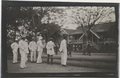 Men in white suits watching a march past of the Australian Naval and Military Expeditionary Force, Rabaul?, approximately 1914