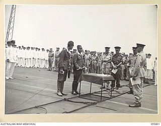 AT SEA OFF RABAUL, NEW BRITAIN. 1945-09-06. LIEUTENANT GENERAL V.A.H. STURDEE, GENERAL OFFICER COMMANDING FIRST ARMY TALKING TO GENERAL H. IMAMURA, COMMANDER EIGHTH AREA ARMY, THROUGH AN ..