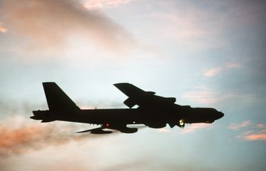 A right side view of a B-52 Stratofortress aircraft taking off at sunset during Exercise DISTANT MARINER