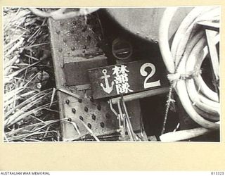 1942-10-01. NEW GUINEA. MILNE BAY. THE NUMBER PLATE OF A JAPANESE PETROL WAGGON CAPTURED BY AUSTRALIAN TROOPS DURING THE UNSUCCESSFUL JAPANESE ATTACK ON MILNE BAY