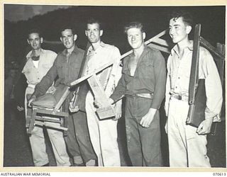 PORT MORESBY, PAPUA, 1944-02-25. AUSTRALIAN AND AMERICAN TROOPS ARRIVING FOR A PICTURE SHOW AT AN AMERICAN HOSPITAL IN PORT MORESBY. ALL TROOPS BRING THEIR OWN SEATS