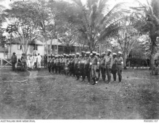 RABAUL, NEW GUINEA, C.1914. GERMAN HEADQUARTERS AFTER CAPTURE BY THE AUSTRALIAN NAVY AND MILITARY EXPEDITIONARY FORCE (AN&MEF). A NATIVE NEW GUINEA GUARD IS LINED UP OUTSIDE. (ORIGINAL ALBUM HELD ..
