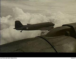 New Guinea. 1943-07-20. Two Douglas C47 Dakota aircraft of the United States Air Force en route to the Wau and Bulolo area to carry out supply dropping missions to Allied troops in forward ..