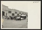 A bus arrives at a pier in Los Angeles Harbor from the Santa Ana housing project with a group of