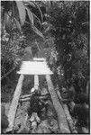 Bridge-building: men place planks for deck