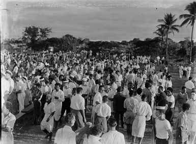 [Large outdoor gathering of servicemen and pacific island men and women]