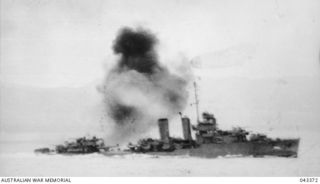 OFF TULAGI, 1942-08-07. DURING THE LANDING ON TULAGI, JAPANESE AIRCRAFT ATTACKING THIS UNITED STATES DESTROYER, WHICH WAS HIT BY A BOMB. THIS PHOTOGRAPH TAKEN AS THE BOMB HITS. (SEE ALSO PHOTOGRAPH ..