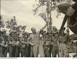 TOROKINA, BOUGAINVILLE ISLAND, SOLOMON ISLANDS. 1945-01-19. 28805 LEADING AIRCRAFTMAN K. DOBSON OF ADELAIDE, SA, PROUDLY EXPLAINS THE ROLE OF THE BOOMERANG AIRCRAFT OF NO. 5 (ARMY CO-OPERATION) ..