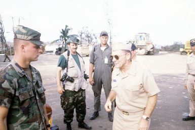 RADM William Retz, commander, Naval Base, Pearl Harbor, converses with a soldier who is assisting in transporting supplies by landing craft from the amphibious assault ship USS BELLEAU WOOD (LHA-3) to the island of Iauai. The delivery is part of Joint Task Force Garden Isle, a joint military disaster relief effort which was organized to provide assistance to the residents of the region in the aftermath of Hurricane Iniki