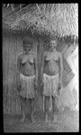 Two young women in front of a house