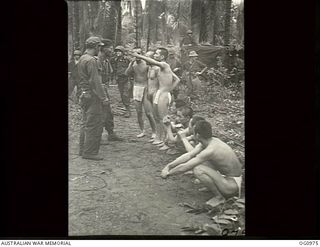 AITAPE AREA, NORTH EAST NEW GUINEA. C. 1944-04. US TROOPS TALKING WITH NAKED AND SCANTILY CLOTHED JAPANESE PRISONERS OF WAR (POWs) FOLLOWING THE SUCCESSFUL ALLIED LANDING. THE JAPANESE WERE ..