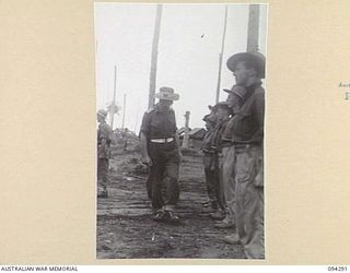 KARAWOP, NEW GUINEA. 1945-07-19. MEMBERS OF F FORCE, 2/1 TANK ATTACK REGIMENT, ATTACHED 2/6 CAVALRY (COMMANDO) REGIMENT, BEING INSPECTED BY LIEUTENANT COLONEL E.C. HENNESSY