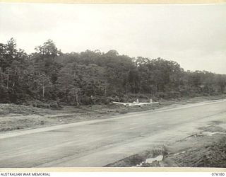 FINSCHHAFEN, NEW GUINEA. 1944-09-20. A UNITED STATES ARMY AIR FORCE P-38 LOCKHEED LIGHTNING AIRCRAFT FLYING LOW OVER THE AIRFIELD AT APPROXIMATELY 300 MILES PER HOUR