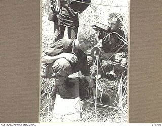 NEW GUINEA. GONA. THESE AUSTRALIANS HAVE JUST COME 100 YARDS BACK FROM THE FRONT LINT FOR FOOD DURING A LULL IN THE FIGHTING THEY ARE PART OF A COMPANY WHICH HAS BEEN 2 DAYS AND NIGHTS WITHIN ..